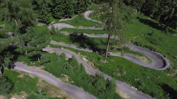 Drone shot of a mountain biker. Riding on a flow trail in Austria. Follow shot from above.