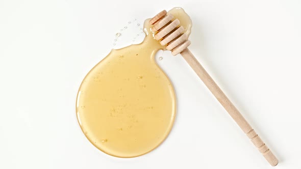 Rotation of the Composition with Fresh Honey on a White Background Top View