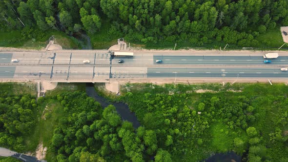 Aerial View of Trucks and Cars Driving Fast Along the Suburban Highway