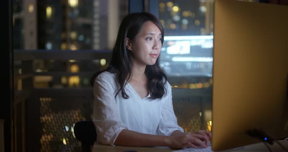 Woman work on computer at night