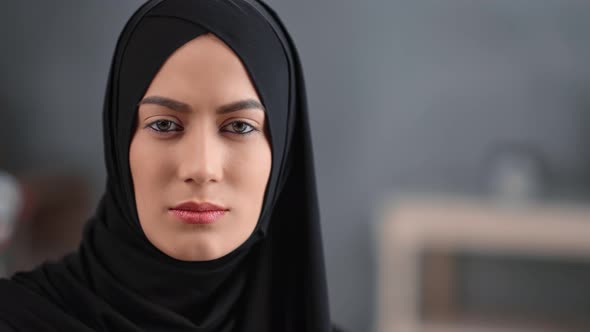 Pretty Arabic Woman in Black Hijab Posing at Comfortable Modern Home