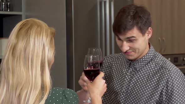 Handsome Man Clinking Glasses with His Girlfriend Celebrating Buying New Home