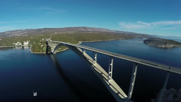 Aerial shot of cars driving on Krk Bridge