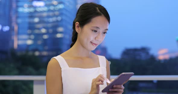 Woman use of mobile phone at night