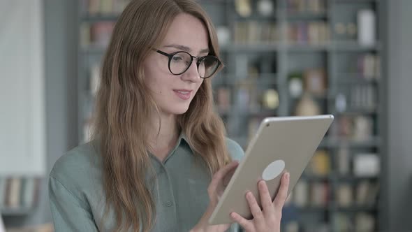 Portrait of Young Woman Using Tablet in Office