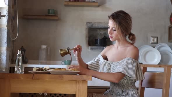 Young girl with cup of coffee on greek kitchen. Crete, Greece