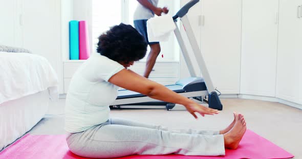 Woman exercising while man jogging on treadmill 4k