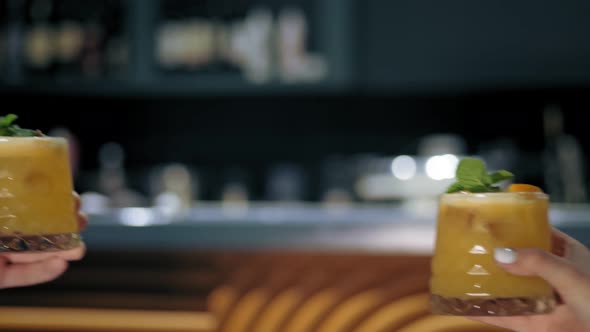 Close Up of Two People Are Cheering with Cocktails in the Bar Restaurant or Disco Club