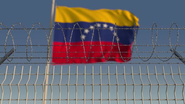 Barbed Wire Against Waving Flag of Venezuela