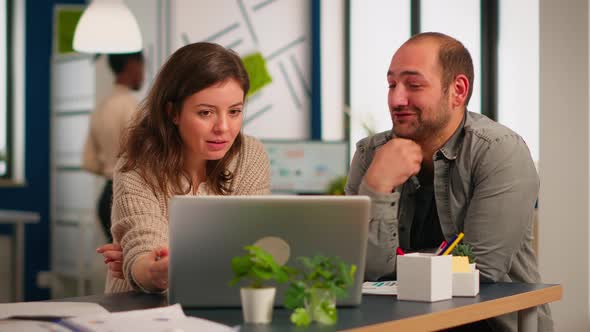 Woman Manager Pointing on Laptop Showing New Startup Idea To Coworkers