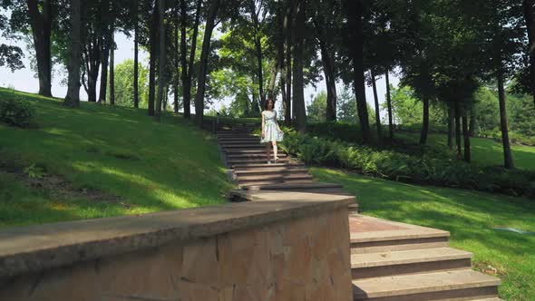 Young Girl in a Bright Dress Hurry Walk