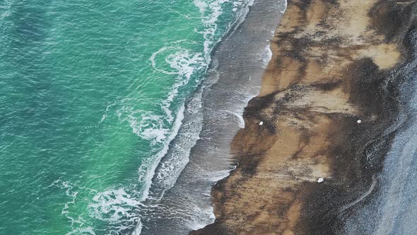 Aerial Drone of Turquoise Blue Ocean Waves Breaking on Sandy Beach, Top Down View of Patterns and Be
