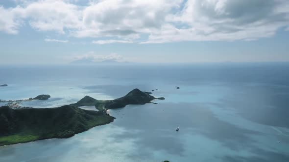 Bird's eye view panorama of azure sea and island with mountains in Five Islands, Antigua and Barbuda