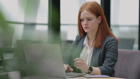 Successful Businesswoman is Working with Laptop in Office Pretty Lady in Grey Jacket Reading