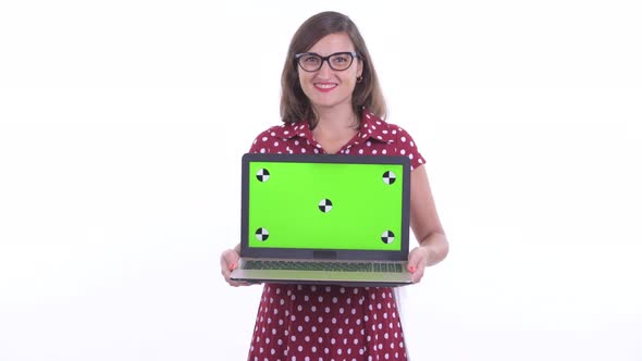 Happy Beautiful Woman with Eyeglasses Thinking While Showing Laptop