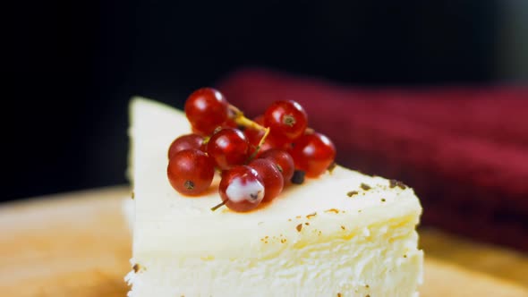 A Slice of Cheesecake Cake with a Sprig of Currant