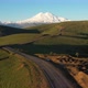Top view of green field, winding roads and Caucasus mountains.Sunrise above Mount Elbrus - VideoHive Item for Sale