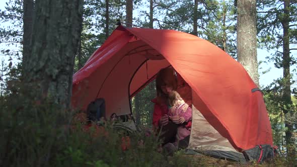 Young Family of Mother and Daughter Having Happy Vacation in Camping in Autumn