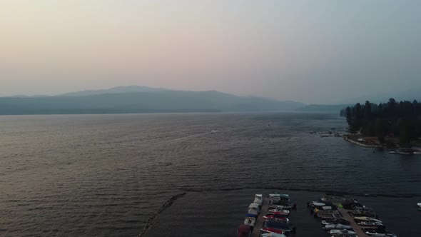 Drone shot of boats in the marina and the shore of Lake Payette in McCall, Idaho during sunset on a