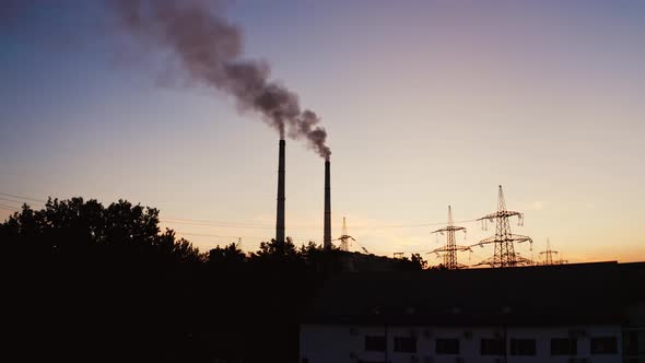 Industrial pipes of the thermal power plant at sunset