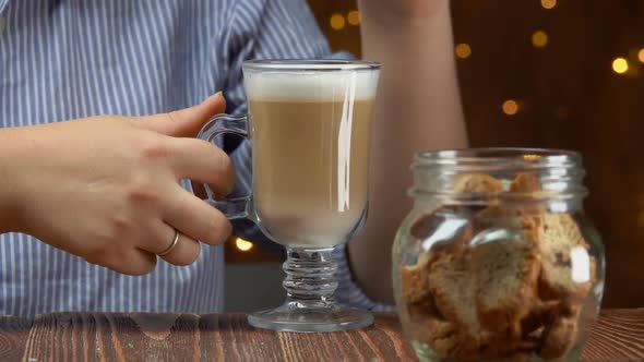 Woman Dips Cantucci Coockies in Latte Coffee