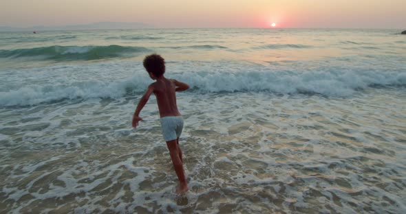 in the Waves of the Sea a Naked AfricanAmerican 68 Year Old Boy Dances for His Own Pleasure