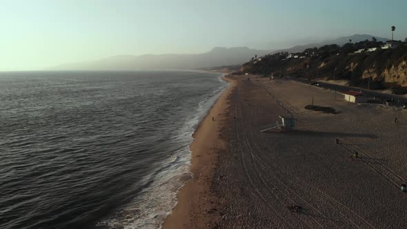 An Aerial Shot Over the Beach in Malibu in California Near the Point Dume Cliffs in the Evening as t