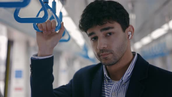 Portrait of Man in Wireless Earphones Standing at Subway