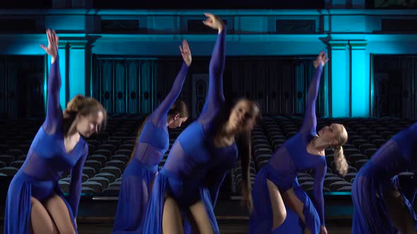 Group Young Skillful Ballerinas Dancing Modern Ballet on the Stage of Large Hall. Girls Looking at