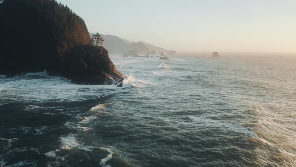 Bird's Eye View of Ocean Waves Crashing Against Stone Rock Cliffs Oregon Coast