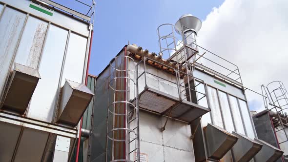 Modern factory outdoors. Huge industrial background of a new plant under blue sky.