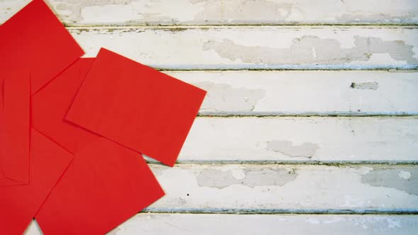 Red envelopes on wooden plank