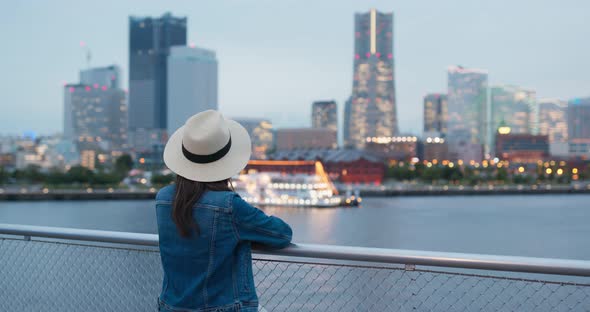 Woman look at the city view in yokohama at night