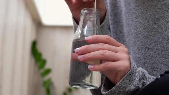 Young Millennial Blonde Woman Drinking Water From Eco Bottle with Metal Reusable Straw Tube and