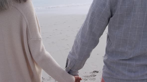 Mature couple enjoying time outside by the sea