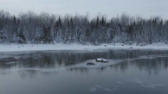 Winter wonderland frozen lake snowy forestry Aerial