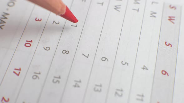 Write the Day on a Paper Calendar with a Red Pen