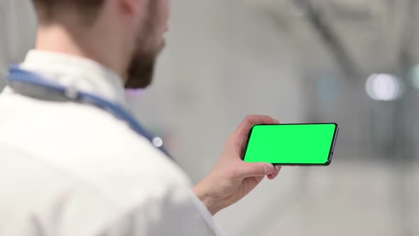 Male Doctor Watching Something on Smartphone with Chroma Screen