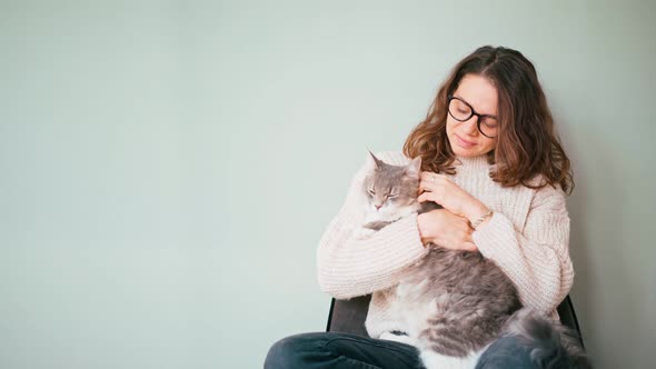 An Attractive Young Woman Petting Her Cat