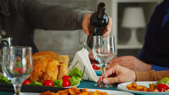 Close Up of Young Man Pouring Red Wine