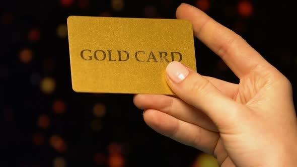 Womans Hand Holding Gold Card, Benefits for VIP Clients in Casino, Gambling