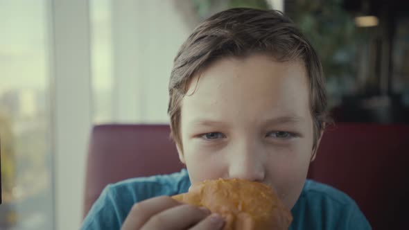 Footage Happy Young Teenager Eating Tasty Burger in Fast Food Restaurant