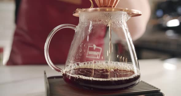 Process of V60 Barista at Work Make a Coffee in a Transparent Glass Bowl