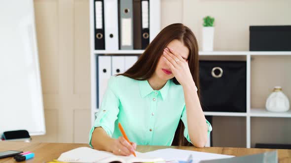 Tired manager getting hit with paper ball in office