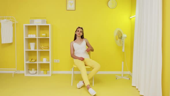 Portrait of Caucasian White Woman Sitting In Yellow Office