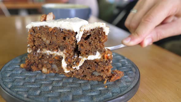 Fork Breaking a Vegan Sugarfree Carrot Cake and Showing It to the Camera