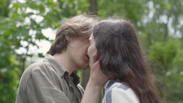 Portrait of Cute Young Couple Tenderly Kissing