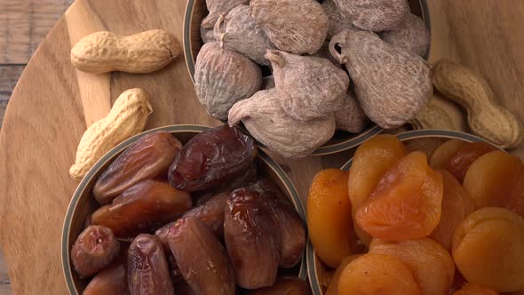 Dried fruit composition on turntable, figs, apricots, dates