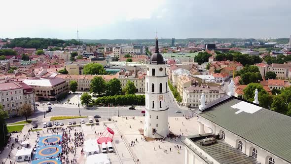 Vilnius Cathedral bell tower and majestic old town rooftops, aerial ascend