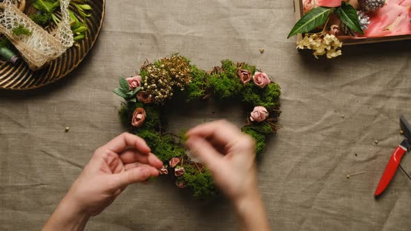 Hands Decorates Floral Wreath for St